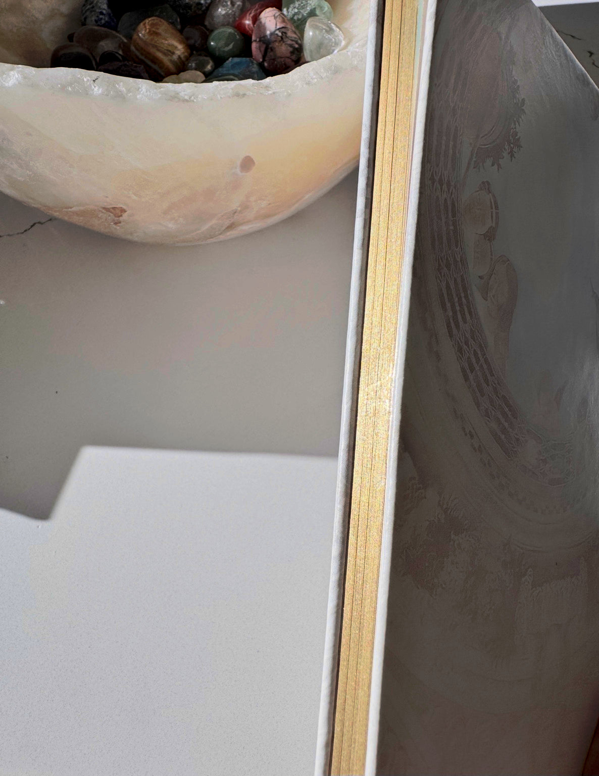 Close-up of the Posoulo journal gold-brushed page-edge treatment