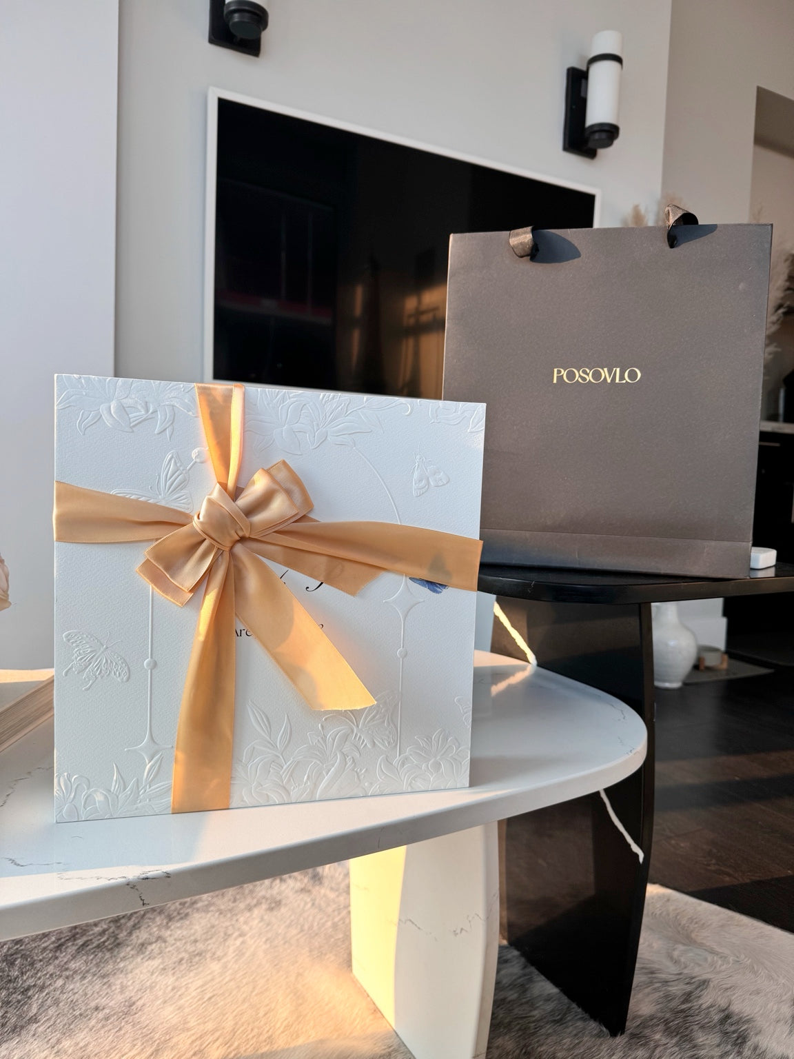 Posoulo white relief-printed gift box with gold ribbon and premium matte black POSOVLO tote bag