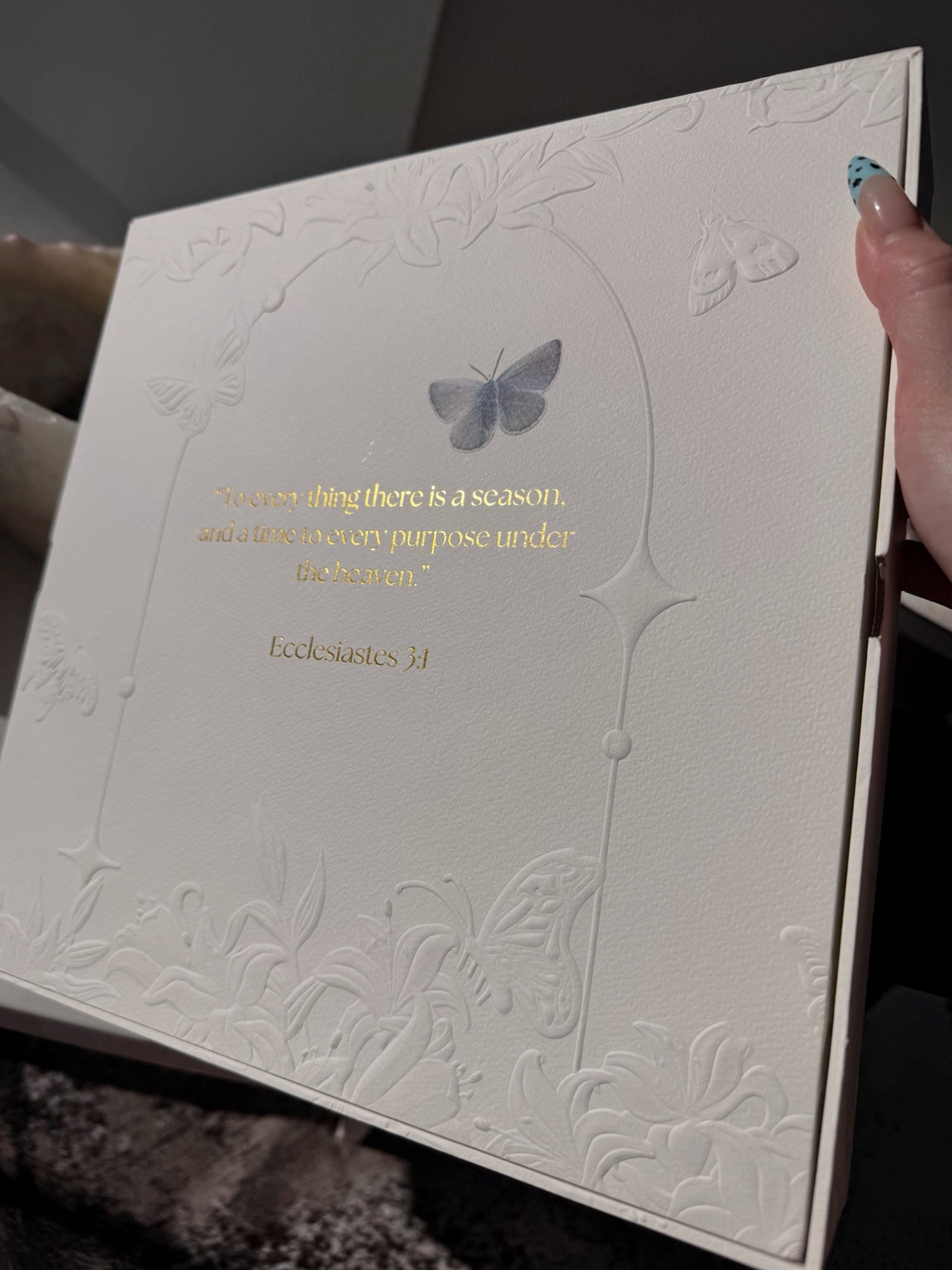 Angled view of the Posoulo gift box back with butterfly artwork and Ecclesiastes 3:1 quotation