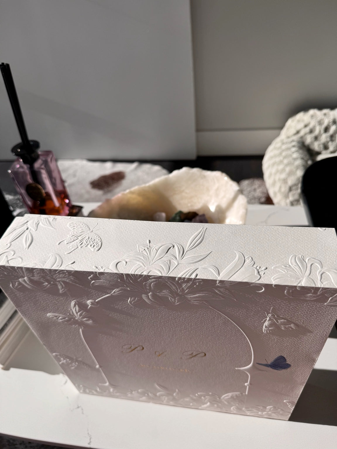 Close natural-light view of the Posoulo gift box relief printing and P and P front design